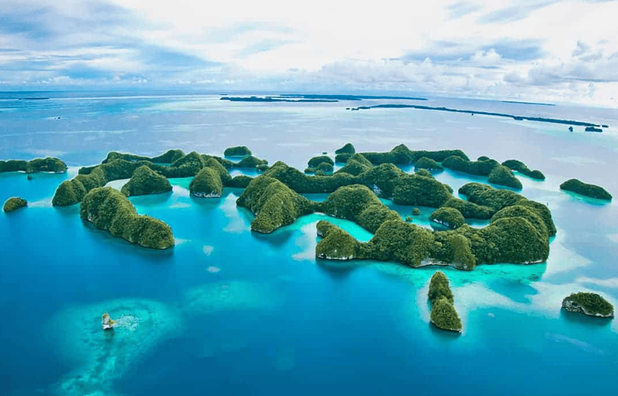 Palau Rock Islands | Sunreef Scuba Diving Expedition October 2027 Aerial view of Palau's famous Rock Islands surrounded by turquoise lagoons and tropical waters, featured on Sunreef's October 2027 scuba diving expedition.